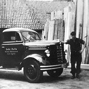 First DOLLE employee standing in front of an old truck