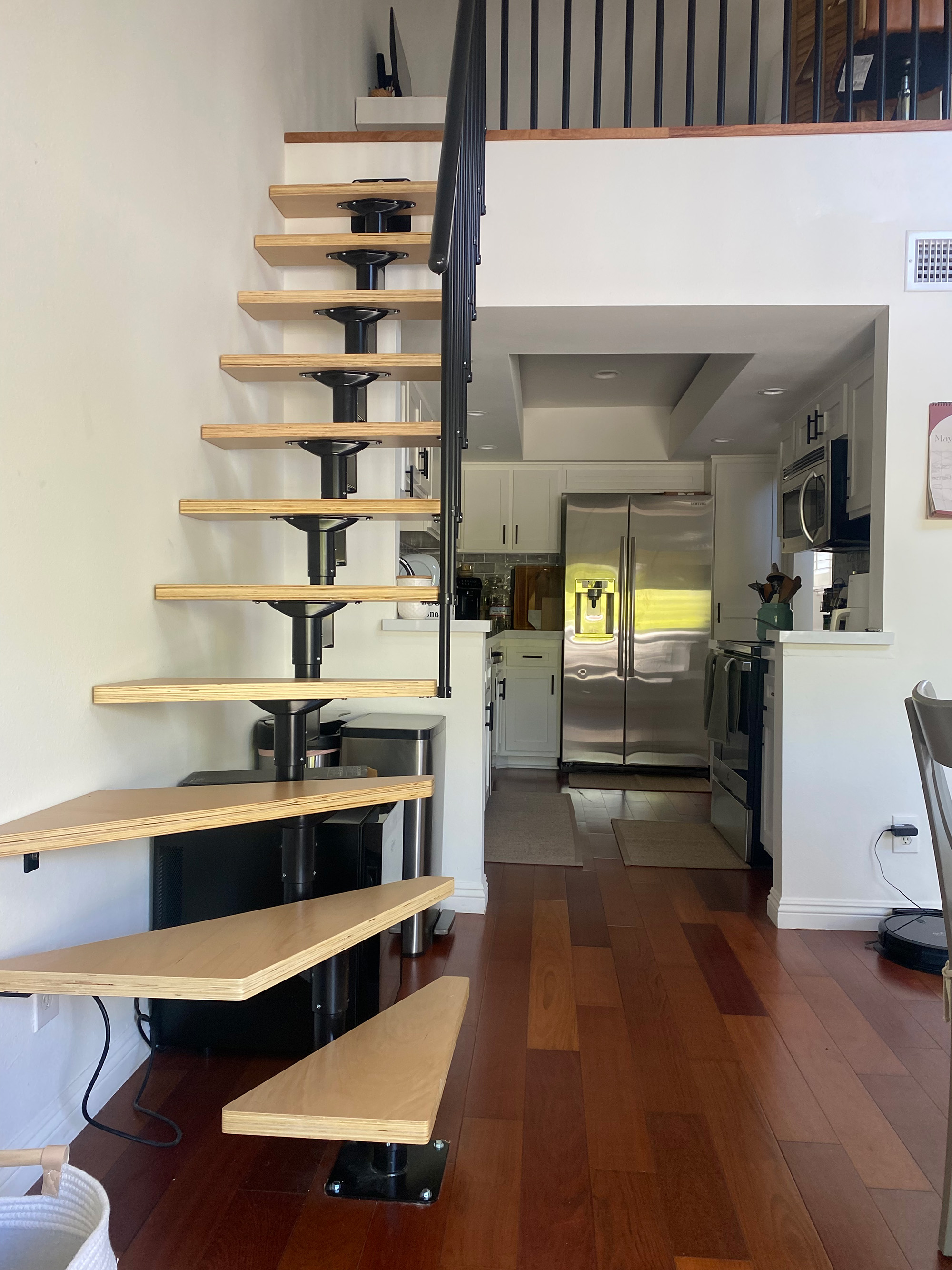 Small Quarter turn staircase in black in a small kitchen 