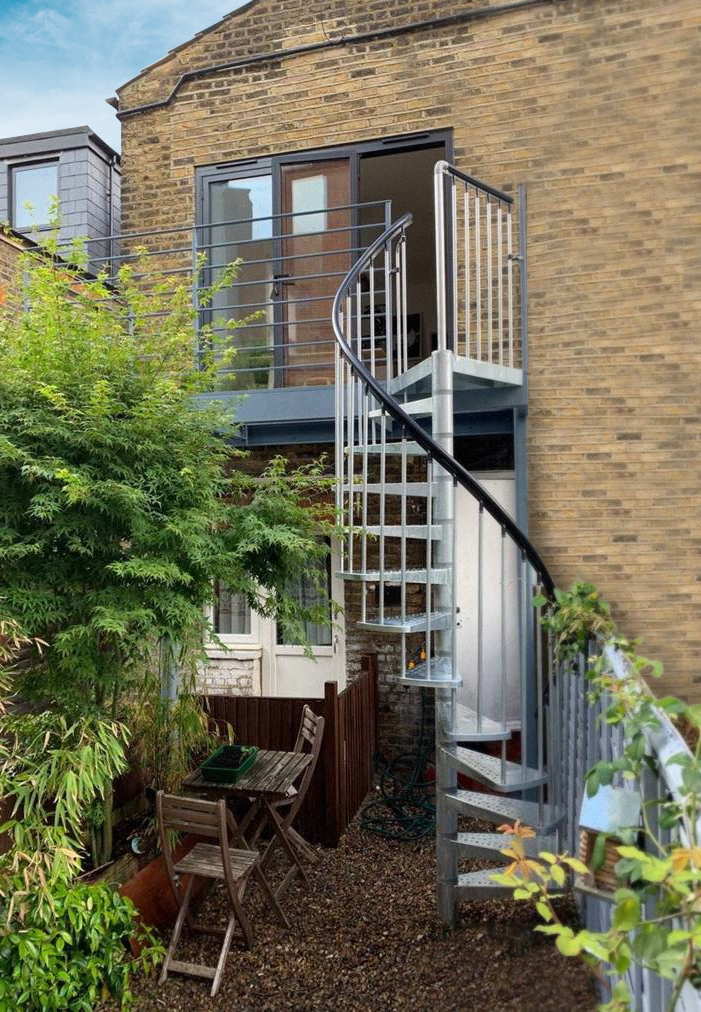 Backyard with TORONTO spiral staircase leading to private garden