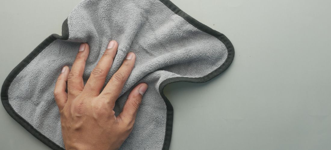 Hand on cloth - cleaning of products